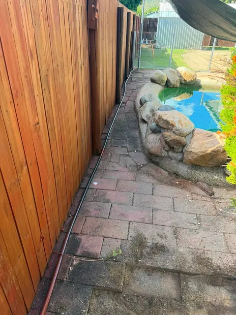 Before: the old brick pavers beside the pool