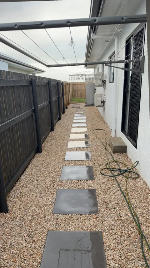 Stepping stones set in decorative stone along a side access