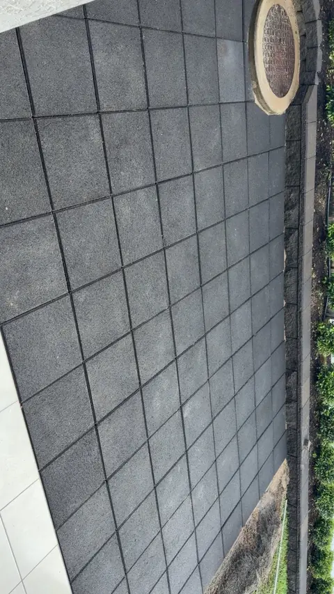 Charcoal 400x400 pavers laid along a wall